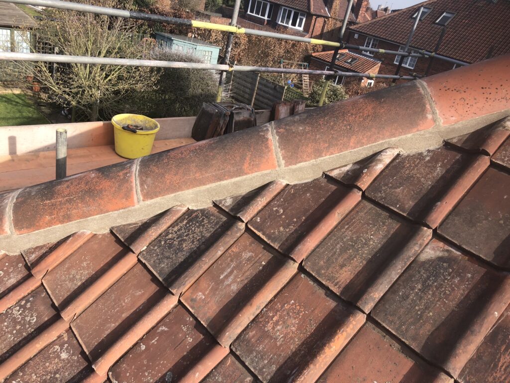 Roof with new ridge tiles
